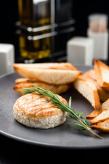 french appetizer grilled camembert with baguette and rosemary