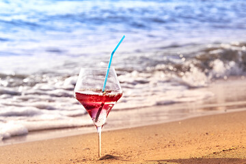 Wine glass with a cocktail by the sea.
