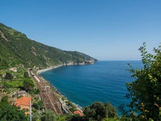 Fototapeta na wymiar Railway station tracks over the bay next to the cliff gulf in Cinque Terre National Park in Italy in city.