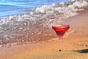 Wine glass with a cocktail by the sea.