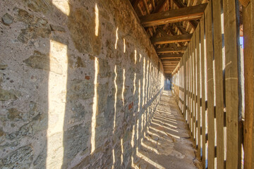 Stone city wall way of Rothenburg, with sun light effects hitting and illuminating it