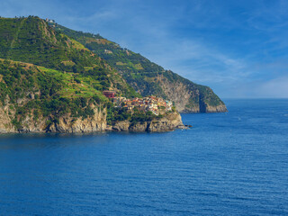 Fototapeta na wymiar City on cliff rock on sea and gulf in Cinque Terre National Park in Italy in city.