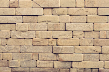 A wall of sandstone bricks.