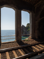 Tunnel railway over with view to cliff gulf in Cinque Terre National Park in Italy in city.