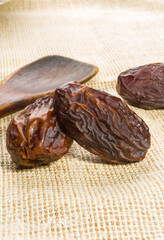 Big luxury dried date fruit on a linen napkin, kurma ramadan kareem concept, close up.