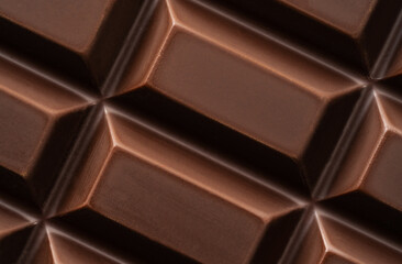 Dark bitter chocolate in cubes shape, close-up, top view.