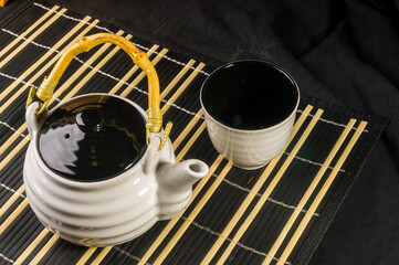 Traditional tea accessories on a bamboo Mat, close-up, macro