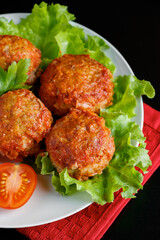 Meat balls in tomato sauce on a black background. Homemade protein meal for healthy diet.