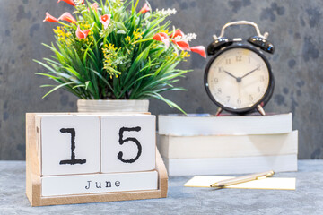 June 15th. June 15 wooden cube calendar with blur objects on background.