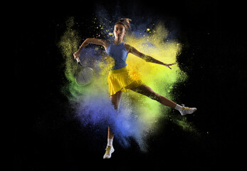 Young girl tennis player in explosion of colored neon powder isolated on dark background. Purple and yellow