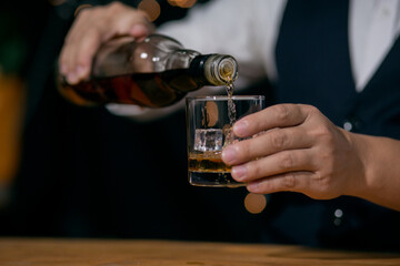Whisky is poured into glass