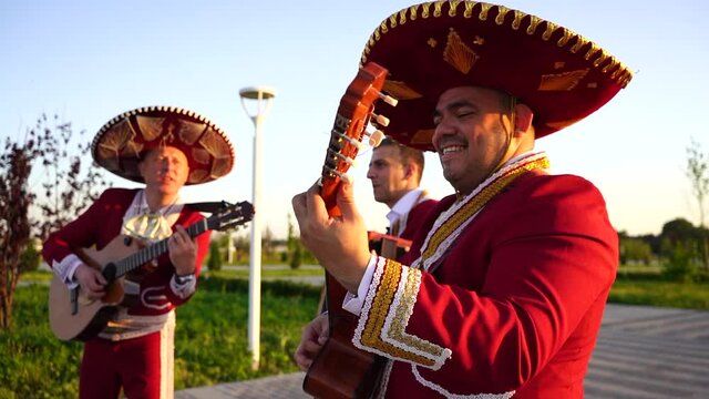 Mexican musicians mariachi band street concert. Slow motion	