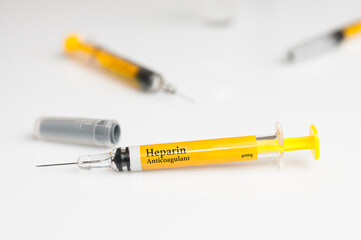 Pre filled heparin syringe on white table