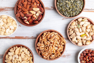 Different kind of nuts in wooden bowls