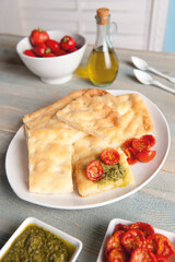 Focaccia with basil pesto and confit tomatoes (ph. Archivio Collection)