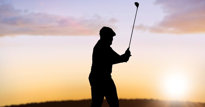 Composition of silhouette of male golf player over landscape and sun setting with copy space