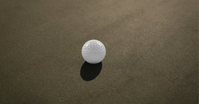 Composition of golf ball on grey asphalt road and copy space