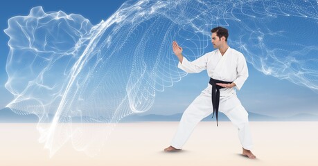 Composition of male martial karate artist with black belt practicing on beach with copy space