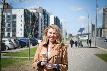 Fototapeta premium Beautiful young caucasian woman portrait eating ice cream at the city street on a summer