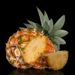  Whole pineapple and cut in half isolated on black background. Picture of tropical fruit