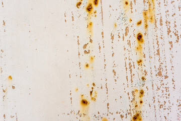 Background of rusty metal wall covered with paint peeling off