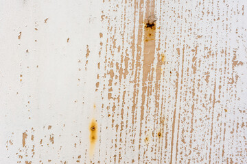 Background of rusty metal wall covered with paint peeling off