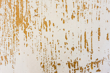 Background of rusty metal wall covered with paint peeling off