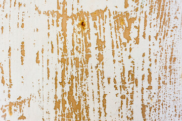 Background of rusty metal wall covered with paint peeling off