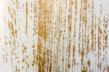 Background of rusty metal wall covered with paint peeling off