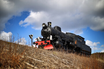 Fototapeta na wymiar Old Swedish steam engine in western-like setting