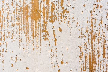 Background of rusty metal wall covered with paint peeling off