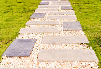 Brick path or sidewalk with perspective going into the distance. Long paved brick footpath outside with grass. - Powered by Adobe