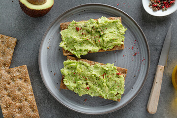 Tasty fresh toast with mashed avocado
