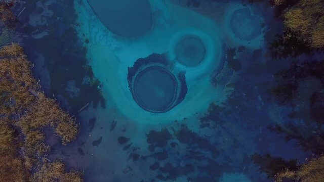 4K Aerial Footage Video of the Autumn Forest and Geyser Lake with Clear Blue Water near the village of Aktash in the Altai Mountains, Russia
