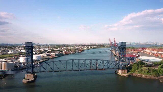 Drone footage of the New Goethals and Arthur Kill vertical lift bridges, with pullback camera motion, between Elizabeth, NJ and Staten Island, NY