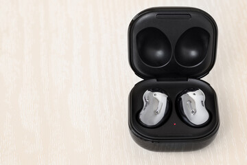 Wireless headphones in a case
on a light wood background