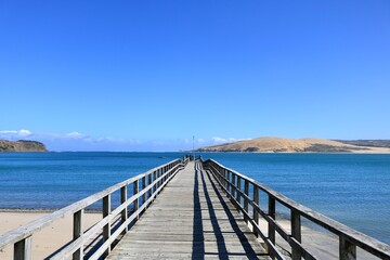 Fototapeta na wymiar 青い空と海にかかる木製の桟橋【ニュージーランド北島】 