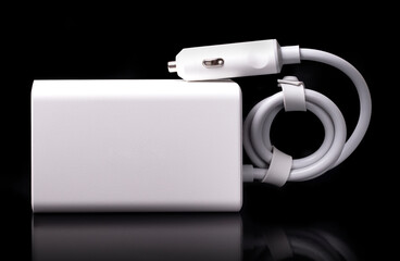 Compact white car inverter on black background