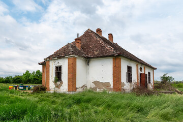 Fototapeta na wymiar Beehives next to an old abandoned house