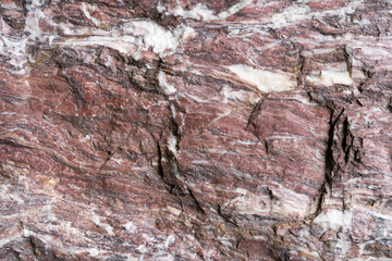 Rot weißer Naturstein mit sehr grober Oberfläche in Nahaufnahme