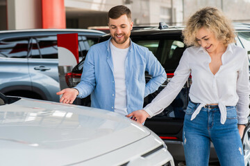 Couple looking at the new car in the dealership