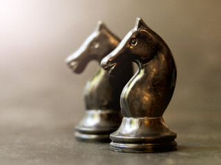 Two black horse chess pieces, retro