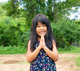Fototapeta premium portrait of an adorable little Asian girl dresses casually smiling standing looking at the camera. Family, holiday, happy and healthy children concept