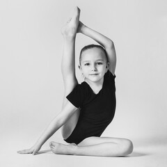 little gymnast demonstrates flexibility and balance in a gymnastic pose