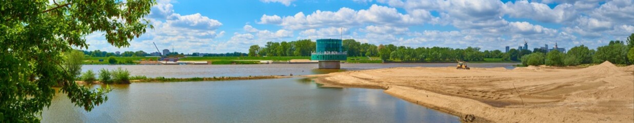 Gruba Kaska – water filtration station on the Vistula river in Warsaw. Panorama overlooking the river and sand on the shore