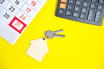 Calendar End of the Month Calculator Keys to a House or Apartment on a Yellow Background.