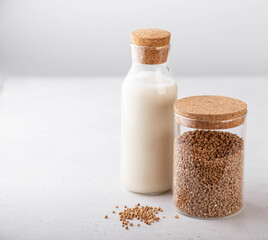 buckwheat and buckwheat milk on a white background, gluten-free concept, copy space