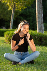 Fototapeta premium Young blonde woman sitting in the park