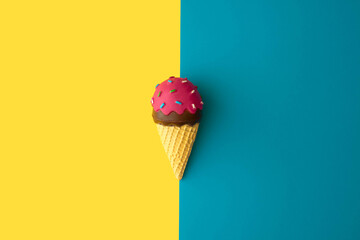 Minimal layout concept with ice cream on blue and yellow background.