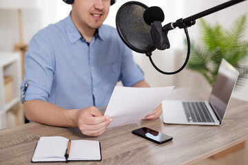 journalism, news, audio content, podcast and blogging concept - man podcasting and recording online...